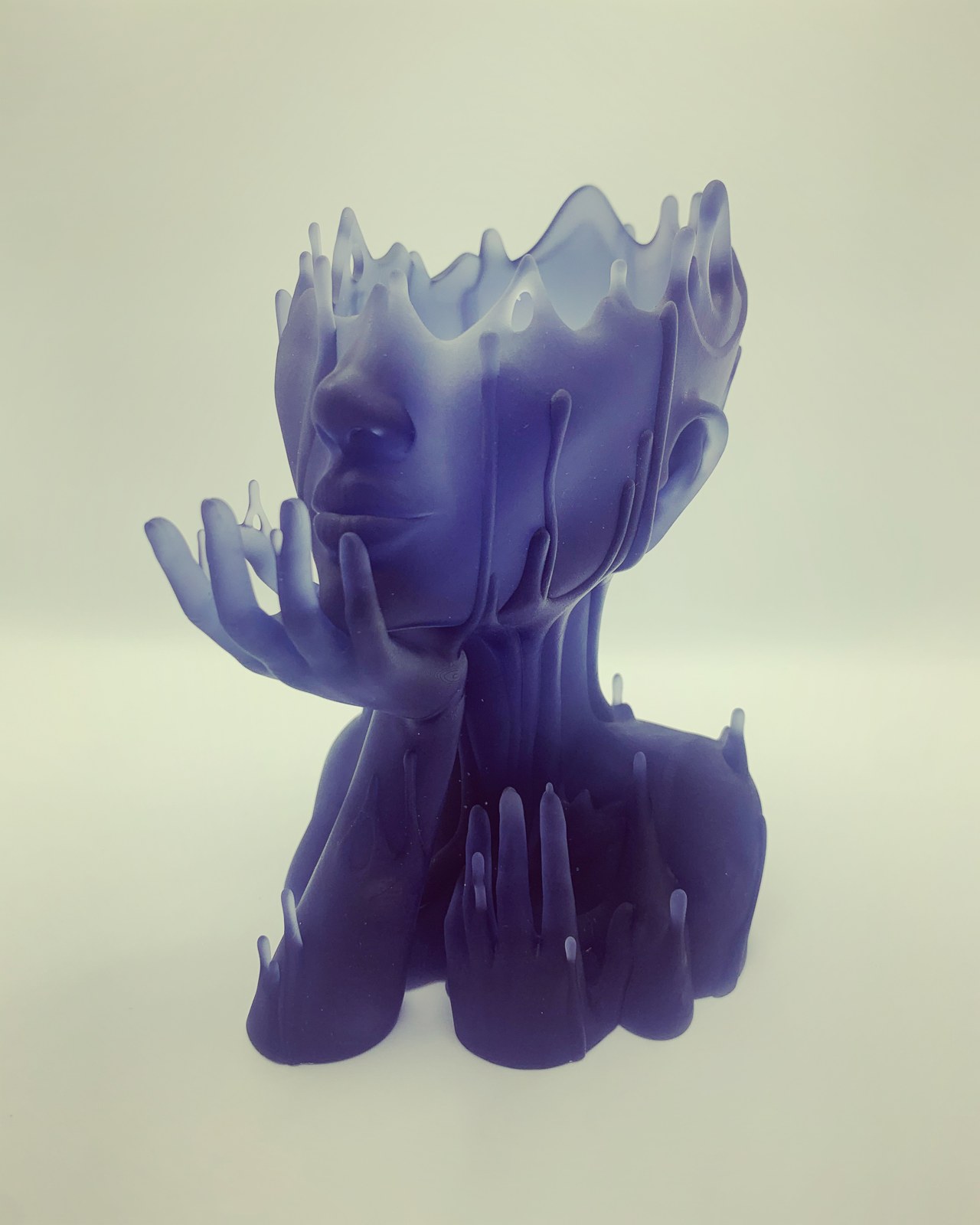 Melted Girl resin bust with a melted crown silhouette and raised hands framing the face.